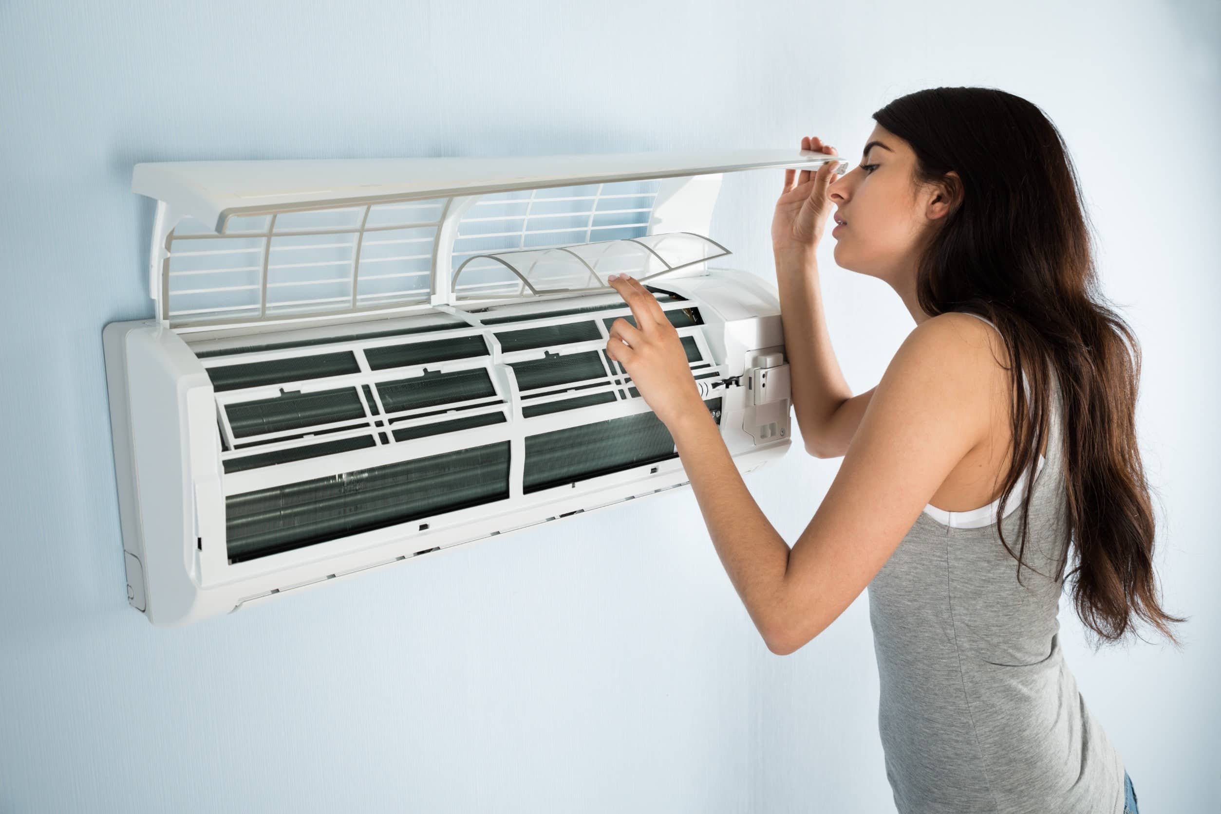 woman checking broken AC in New Jersey