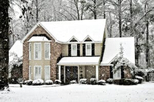 Winter snow falling on an executive home