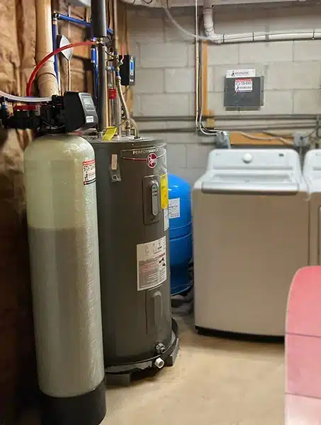 Water softener paired with electric water heater and pressure tank in West Milford area home