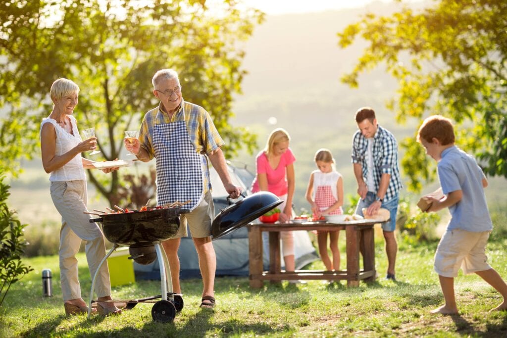 family enjoying an outdoor summer bbq