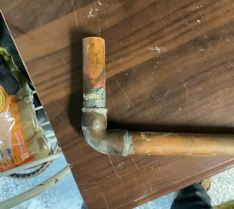 Corroded copper pipe piece