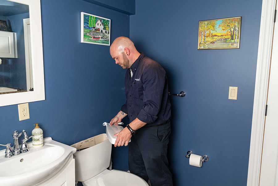 Plumber working in home bathroom in West Milford NJ