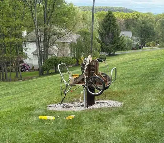 Well pump installation in progress with water flowing at a residential property serviced by Mark Lindsay Plumbing
